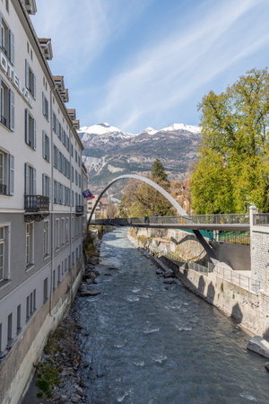 Chur, Switzerland, April 11, 2022 Modern Plessur bridge with a bow over the small river in the city centerのeditorial素材