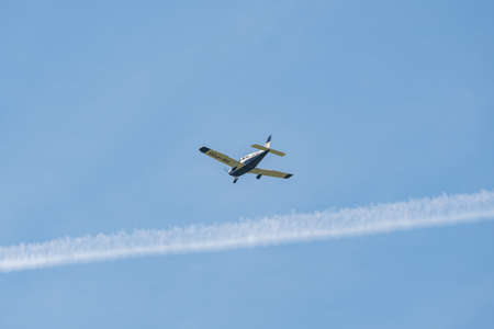 Lommis, Switzerland, May 11, 2022 Piper PA28-181 Archer III propeller plane in the blue sky