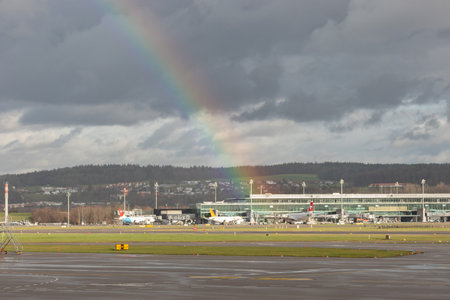 Zurich, Switzerland, December 23, 2022 Colorful rainbow is appearing over the airport after a rain showerのeditorial素材