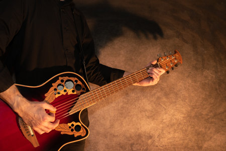 Vaduz, Liechtenstein, January 13, 2023 Artist is performing with an Ovation acoustic guitar in redのeditorial素材