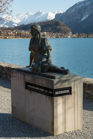 Brienz, Switzerland, February 10, 2023 Statue in honor of the poet Albert Streich at the coast of the lake of Brienzのeditorial素材
