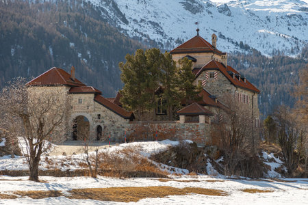 Silvaplana, Switzerland, February 21, 2023 Historic old castle Crap da Sass at the lake of Silvaplana surrounded by an incredible winter panorama on a sunny dayのeditorial素材