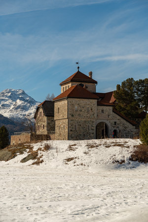 Silvaplana, Switzerland, February 21, 2023 Historic old castle Crap da Sass at the lake of Silvaplana surrounded by an incredible winter panorama on a sunny dayのeditorial素材