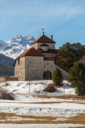 Silvaplana, Switzerland, February 21, 2023 Historic old castle Crap da Sass at the lake of Silvaplana surrounded by an incredible winter panorama on a sunny dayのeditorial素材