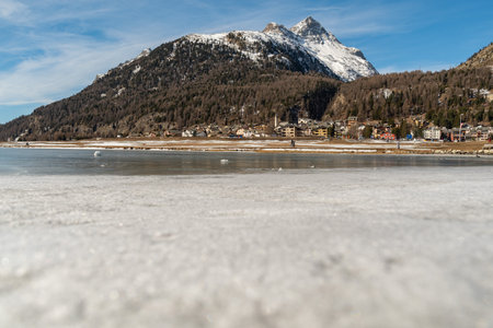 Silvaplana, Switzerland, February 21, 2023 Stunning winter landscape scenery with a frozen lake of Silvaplanaの写真素材