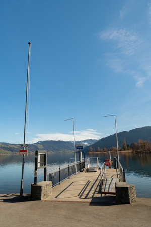 Unteraegeri, Switzerland, February 20, 2023 Boat pier at the coast of the lake Aegeriseeのeditorial素材