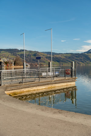 Unteraegeri, Switzerland, February 20, 2023 Boat pier at the coast of the lake Aegeriseeのeditorial素材
