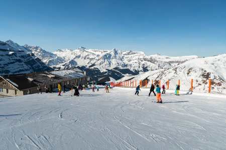 Eigergletscher, Canton Bern, Switzerland, February 11, 2023 Many people on skis are driving down the alpine landscape on a perfect dayのeditorial素材