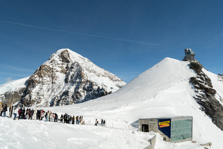 Jungfraujoch, Canton Bern, Switzerland, February 11, 2023 Many people are visiting the top on a sunny winter dayのeditorial素材