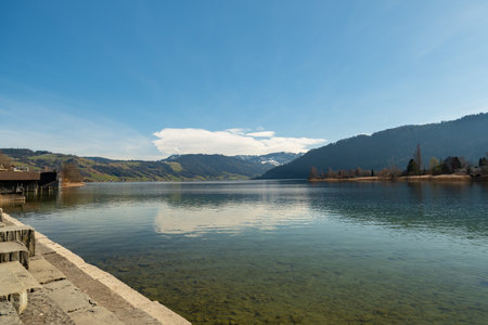Idyllic landscape at the waterfront of the lake Aegerisee on a sunny dayの写真素材