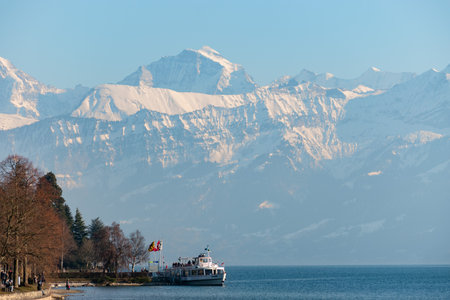 Thun, Switzerland, February 12, 2023 Little boat with passengers on a cruise trip over the lake of Thunのeditorial素材