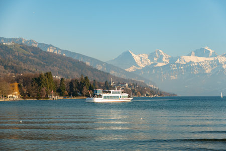 Thun, Switzerland, February 12, 2023 Little boat with passengers on a cruise trip over the lake of Thunのeditorial素材