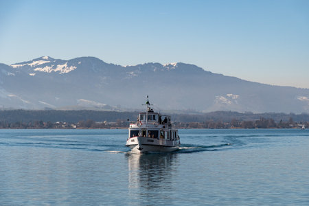 Oberhofen, Canton Bern, Switzerland, February 12, 2023 Small boat is taking tourists to a trip over the lake of Thun on a sunny dayのeditorial素材