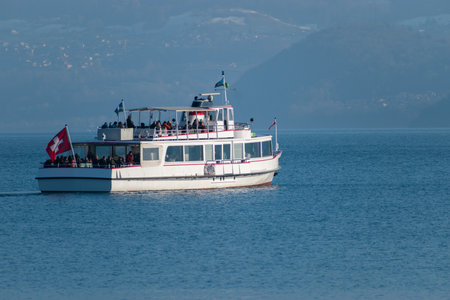 Thun, Switzerland, February 12, 2023 Little boat with passengers on a cruise trip over the lake of Thunのeditorial素材