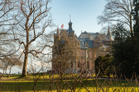 Hilterfingen, Canton Bern, Switzerland, February 12, 2023 Historic old castle Huenegg in a little park on a sunny dayのeditorial素材