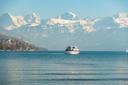 Thun, Switzerland, February 12, 2023 Little boat with passengers on a cruise trip over the lake of Thunのeditorial素材