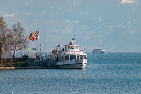 Thun, Switzerland, February 12, 2023 Little boat with passengers on a cruise trip over the lake of Thunのeditorial素材