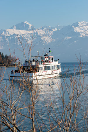 Thun, Switzerland, February 12, 2023 Little boat with passengers on a cruise trip over the lake of Thunのeditorial素材