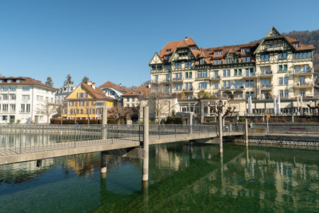 Thun, Switzerland, February 13, 2023 Pedestrian bridge over the Aare river at the waterfront in the city centerのeditorial素材