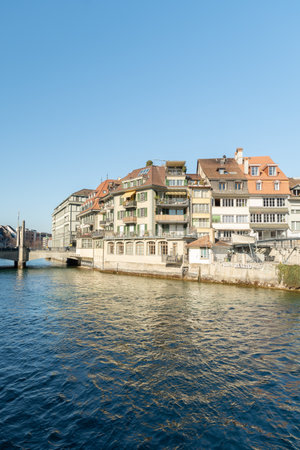 Thun, Switzerland, February 13, 2023 Aare river waterfront in the city center on a sunny dayのeditorial素材