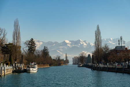 Thun, Switzerland, February 13, 2023 Water promenade at the lake of Thun on a sunny dayのeditorial素材