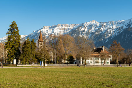 Interlaken, Switzerland, February 10, 2023 View over a green park and a fantastic mountain panorama in the city centerのeditorial素材