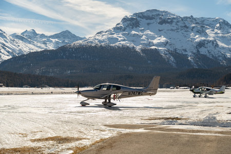 Samedan, Switzerland, February 21, 2023 Cirrus SR22T propeller aircraft is parking on the fieldのeditorial素材