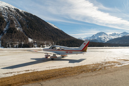 Samedan, Switzerland, February 21, 2023 Piper PA-28-181 Archer II is parking on the fieldのeditorial素材