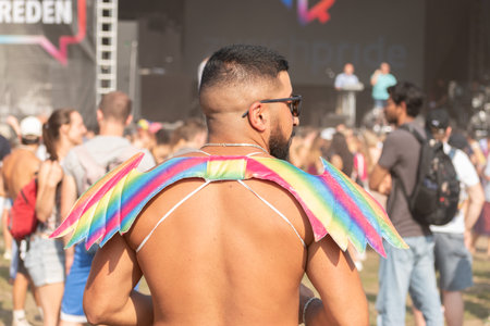 Zurich, Switzerland, June 17, 2023 Person is wearing rainbow colored gender wings at the pride festival in the city centerのeditorial素材