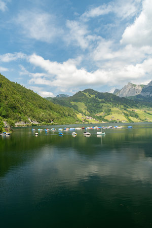 Waegital, Canton Schwyz, Switzerland, June 13, 2023 Little boats are drifting on the surface of the lake Waegitalerseeの写真素材