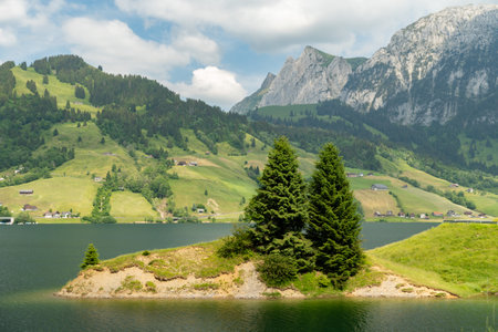 Waegital, Canton Schwyz, Switzerland, June 13, 2023 Fantastic view over the beautiful lake Waegitalersee surrounded by the majestic swiss alps on a sunny dayの写真素材