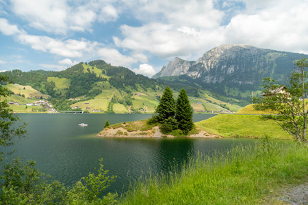 Waegital, Canton Schwyz, Switzerland, June 13, 2023 Fantastic view over the beautiful lake Waegitalersee surrounded by the majestic swiss alps on a sunny dayの写真素材