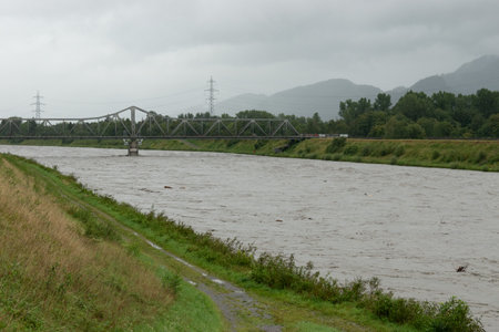 Schaan, Liechtenstein, August 28, 2023 Heavy flood at the rhine river during a severe rain showerの写真素材