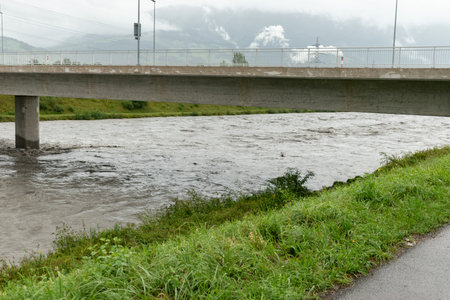 Schaan, Liechtenstein, August 28, 2023 Heavy flood at the rhine river during a severe rain showerの写真素材
