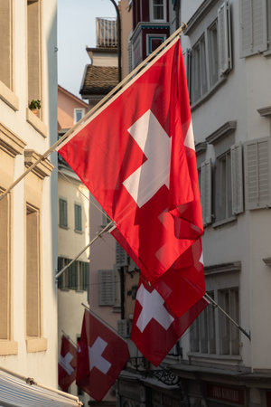 Zurich, Switzerland, June 17, 2023 Swiss flags on facades in the old townの写真素材