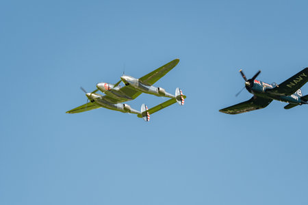 Mollis, Switzerland, August 18, 2023 Lockheed P-38L Lightning and a Chance Vought F4U-4 Corsair aircraft during an air displayのeditorial素材