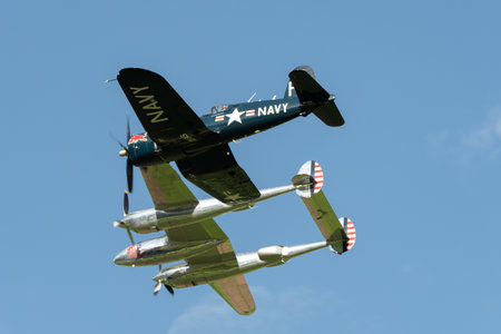 Mollis, Switzerland, August 18, 2023 Lockheed P-38L Lightning and a Chance Vought F4U-4 Corsair aircraft during an air displayのeditorial素材