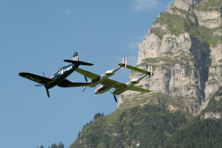 Mollis, Switzerland, August 18, 2023 Lockheed P-38L Lightning and a Chance Vought F4U-4 Corsair aircraft during an air displayのeditorial素材