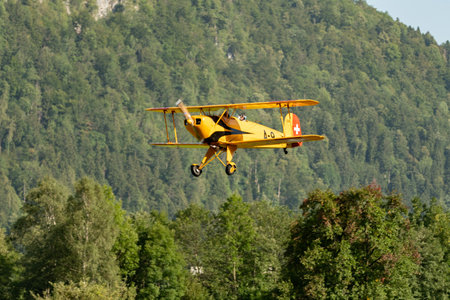 Mollis, Switzerland, August 18, 2023 HB-UUD Buecker 131 Jungmann aircraft landing on runway 19のeditorial素材