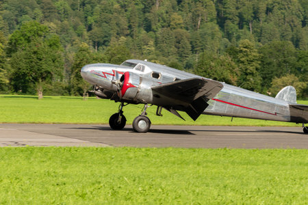 Mollis, Switzerland, August 18, 2023 NC-81125 Lockheed Model 12 Electra Junior aircraft is taxiing on the runwayのeditorial素材