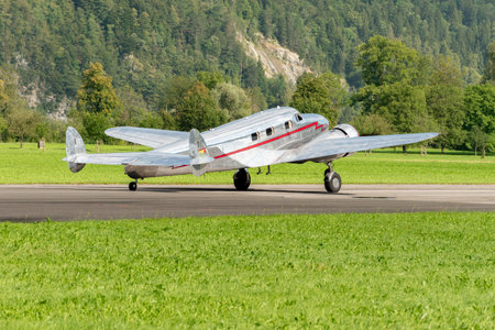 Mollis, Switzerland, August 18, 2023 NC-81125 Lockheed Model 12 Electra Junior aircraft is taxiing on the runwayのeditorial素材