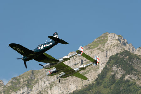 Mollis, Switzerland, August 18, 2023 Lockheed P-38L Lightning and a Chance Vought F4U-4 Corsair aircraft during an air displayのeditorial素材
