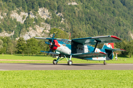 Mollis, Switzerland, August 18, 2023 LY-MHC Antonov AN-2 historic old double decker aircraft is landing on runway 19のeditorial素材