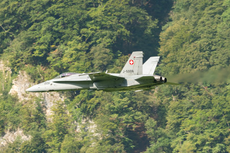 Mollis, Switzerland, August 18, 2023 Swiss military McDonnell Douglas F/A-18 Hornet jet is performing acrobatics during an air displayのeditorial素材
