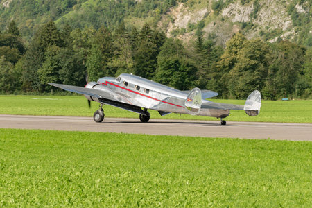 Mollis, Switzerland, August 18, 2023 NC-81125 Lockheed Model 12 Electra Junior aircraft is taxiing on the runwayのeditorial素材