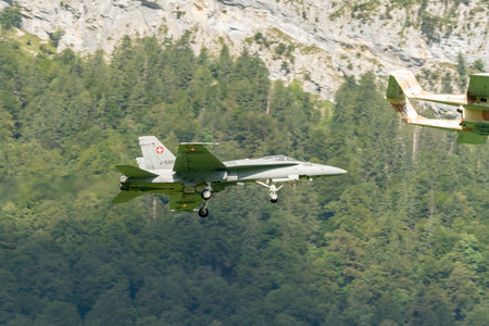 Mollis, Switzerland, August 18, 2023 North american OV-10B Bronco airplane escorted with a McDonnell Douglas F/A-18 Hornet military jet during an air displayのeditorial素材