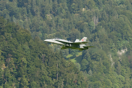 Mollis, Switzerland, August 18, 2023 Swiss military McDonnell Douglas F/A-18 Hornet jet is performing acrobatics during an air displayのeditorial素材