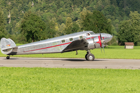 Mollis, Switzerland, August 18, 2023 NC-81125 Lockheed Model 12 Electra Junior aircraft is taxiing on the runwayのeditorial素材