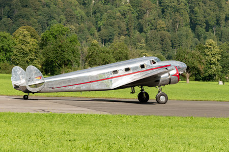 Mollis, Switzerland, August 18, 2023 NC-81125 Lockheed Model 12 Electra Junior aircraft is taxiing on the runwayのeditorial素材