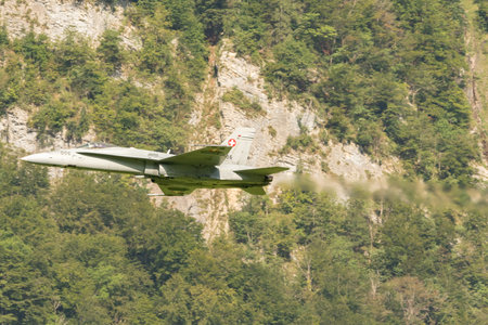 Mollis, Switzerland, August 18, 2023 Swiss military McDonnell Douglas F/A-18 Hornet jet is performing acrobatics during an air displayのeditorial素材